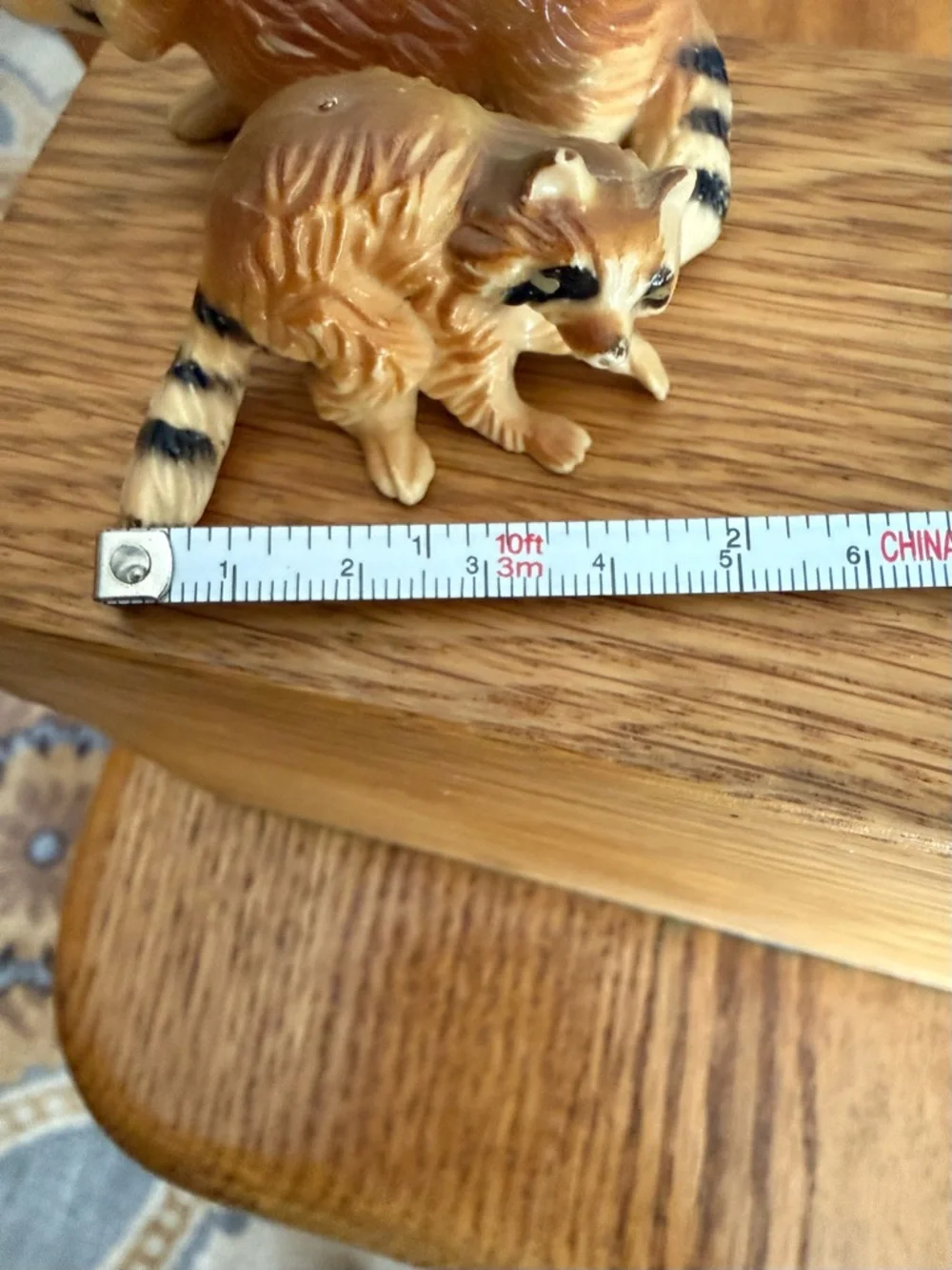 Mini pair of raccoon figurines